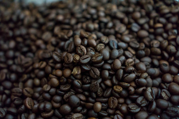 Roasted beans coffee smell like coffee, and weigh less because the moisture has been roasted out....