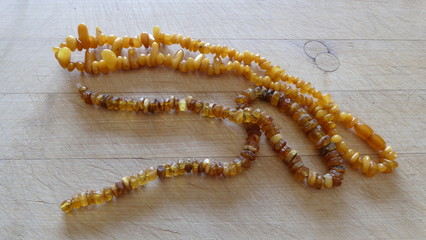 amber beads on a wooden background