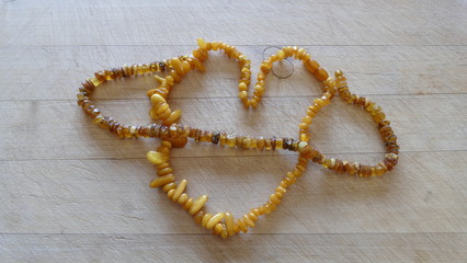 amber beads on a wooden background