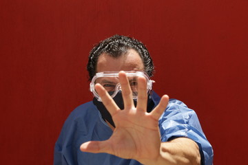 man in a nurse's dress, glasses and covers mouths, in an aggressive attitude, angry, defensive, stop, stop the virus, we are not victorious