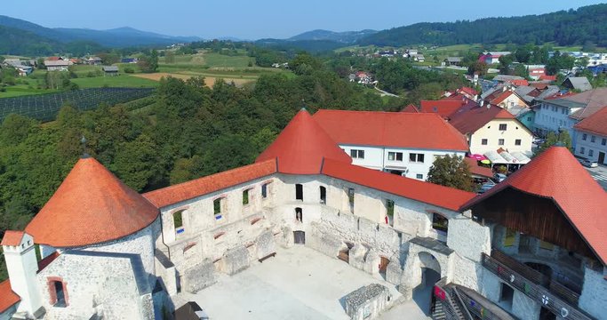 Zuzemberk Castle on top of the hill, surrounding town. Aerial reveal