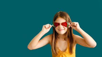 kid 7 years old with watermelon lollipop on green