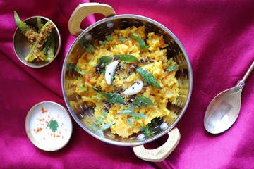 Dal khichadi/Masala Khichdi/daal khichdi tadka is a healthy Indian recipe made of mixed Lentils & rice combined with spices & vegetables. Served with Curd or Yogurt, Papad & chili pickle. Copy Space