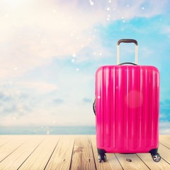 Beautiful colored suitcase on wheels for travel.