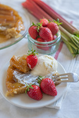 Rhubarb upside down cake with strawberries and ice cream