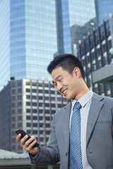 Fototapeta premium Businessman looking at his phone