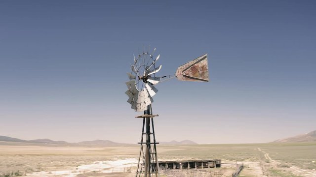 Aerial: Flying over a weather vane on an abandoned ranch. Ely, Nevada, USA
