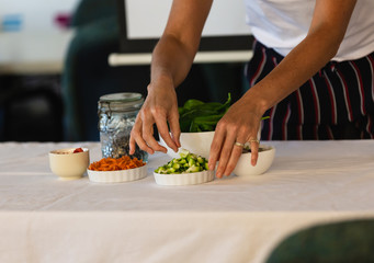 Obraz na płótnie Canvas Woman hands preparing food of a presentation table