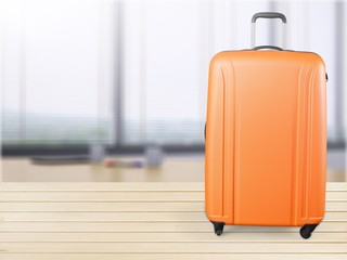 Beautiful colored suitcase on wheels for travel.