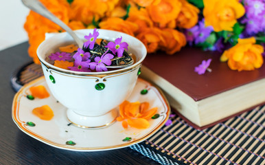 cup of tea with flowers and book
