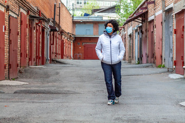 A woman wearing protective mask and gloves during quarantine during corona virus Covid-19 outbreak