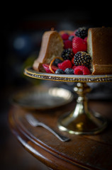 Still life with delicious cake and fresh berries on dark background