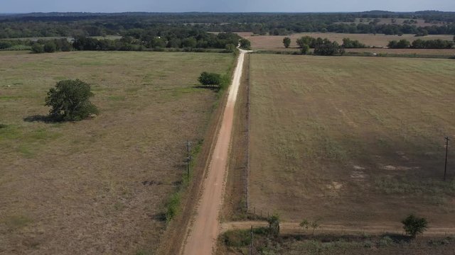 Country Gravel Road with Fields and pastures, Burleson County, Texas, USA