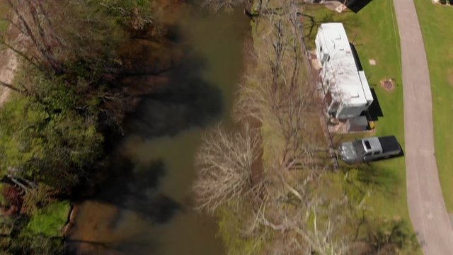 RV Fifth Wheels And Coach Vehicles By River's Edge In Campground, Aerial