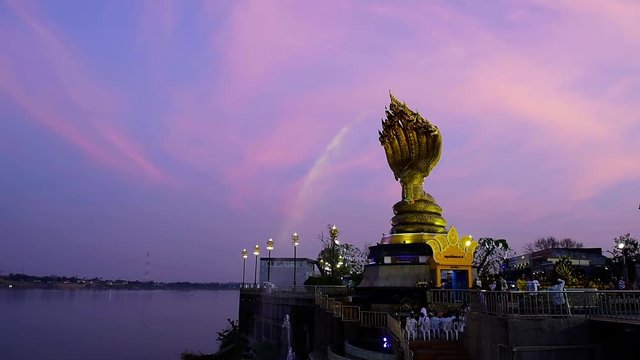 Yard serpent spits water on the Mekong River in Nakhon Phanom, Thailand for foreign traveler and thai people travel visit and respect praying