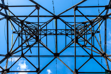 High voltage electric pillar from under. A high-voltage electricity tower
