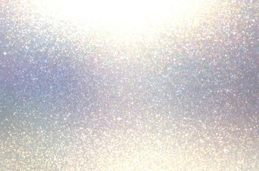 Textured shimmer on light grey blue blur background. Lens flare effect.