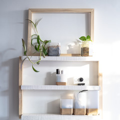 White and wooden shelves furniture and in stylish a room. Dapple light during sunrise. Scandinavian modern korean style.