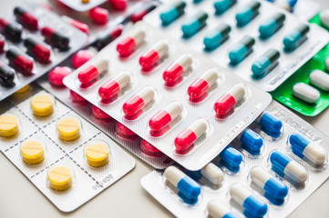 A lot of Colorful Medicine pills, tablets and capsules in packaging.