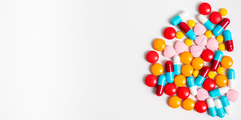 A lot of pills colorful on the white background. Medicine pills, tablets and capsules with copy space for text.