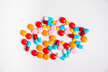 A lot of pills colorful on the white background. Medicine pills, tablets and capsules.
