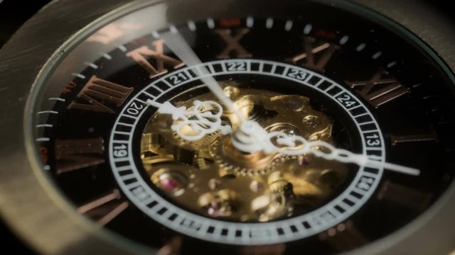 Antique watch mechanism gears running in timelapse 4k extreme macro closeup