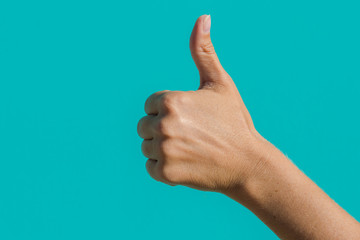 thumb up sign. sign "class" on a turquoise background. Hand shows thumb up