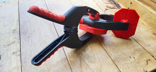 A spring clamp made of nylon resin on the table wooden