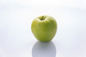 Ripe, green apples on a white background. Farm fruits