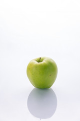 Ripe, green apples on a white background. Farm fruits