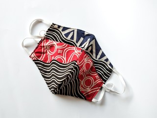 Two pieces of Handmade face mask from batik cloth. Homemade protective mask and pieces of cloth on...