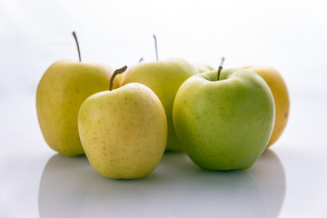 Ripe, green apples on a white background. Farm fruits