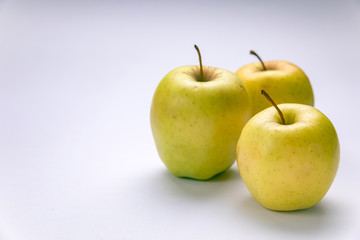 Ripe, green apples on a white background. Farm fruits