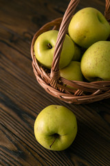 Green and red apples on wooden background
