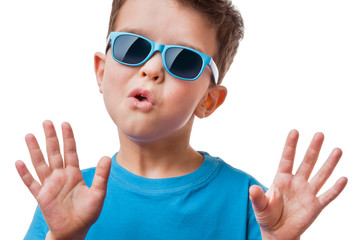 Little boy in sunglasses raised his hands up, isolated on white background
