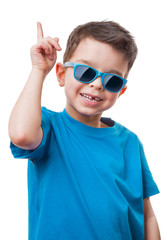 Cheerful little boy in sunglasses showing thumbs up gesture, isolated on white background