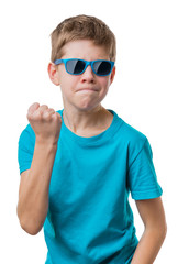 Blond hair serious boy in sunglasses showing his fist, isolated on white background