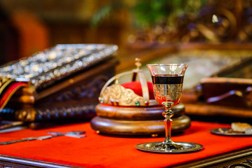 Orthodox christian wedding ceremony - a glass of red wine and crown.