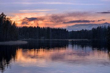 Scenic lake landscape with tranquility mood, sunset and beautiful reflections at spring evening in Finland