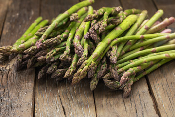 Bunch of fresh green asparagus spears on a rustic wooden table