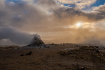 Crowd of smoking chimneys and puddles of boiling water in Hverir, Iceland.