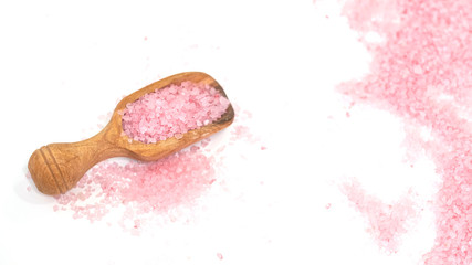 Pink salt isolated in scoop on white background. selective focus or blurry.