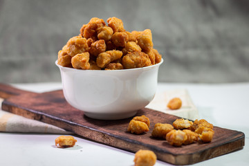 Stock photo of Homemade Crispy Popcorn Chicken with Sauce on white background