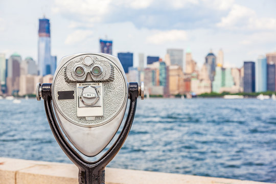 New York City tourism travel background tourist icon - coin operated binocular tower viewer with skyline view in summer. USA destination.
