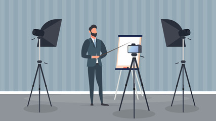 A man in a business suit with a tie is giving a presentation to the camera. The teacher is writing a lesson. The concept of blogging, online training and conferences. Camera on a tripod, softbox. 