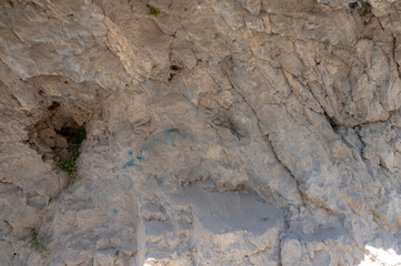mountains of Central Asia. a narrow road between mountains. rapid river and sparse vegetation. there are no people.