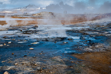 Crowd of smoking chimneys and puddles of boiling water in Hverir, Iceland.