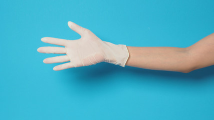 Right hand wearing white glove.Put on blue background.