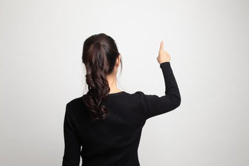 Back of Asian woman touching the screen with her finger.