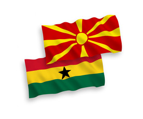 National vector fabric wave flags of Ghana and North Macedonia isolated on white background. 1 to 2 proportion.